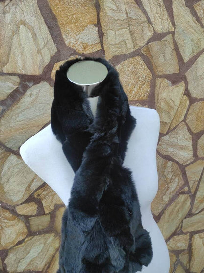 Rex Rabbit Fur Scarf Black - Tatifurs displayed on a mannequin against a stone wall background.