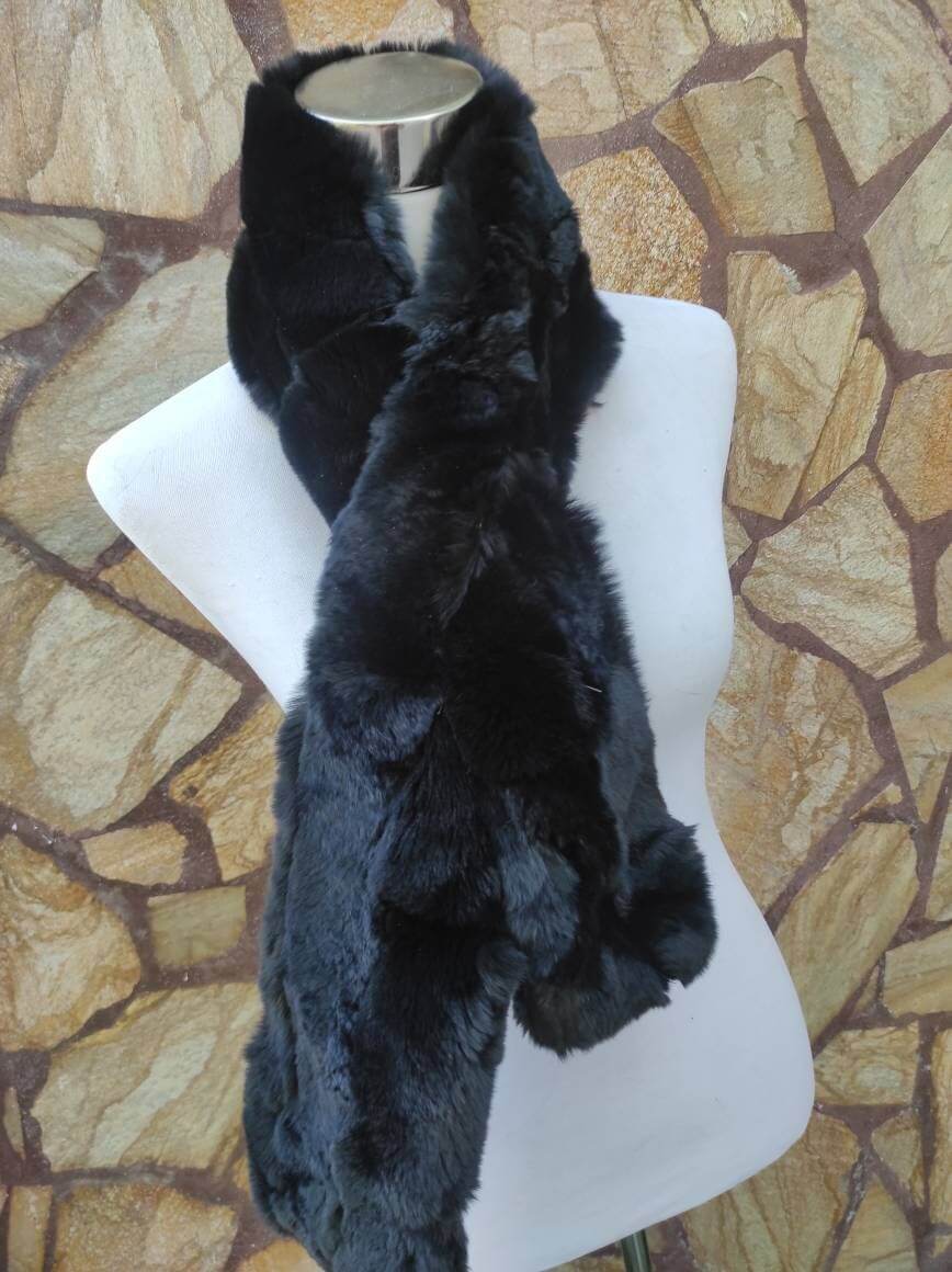 Rex Rabbit Fur Scarf Black - Tatifurs displayed on a mannequin against a textured stone background.