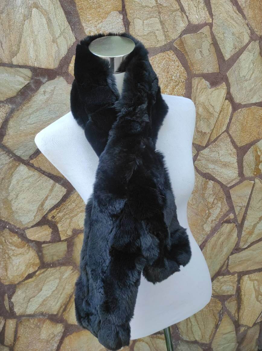 Rex Rabbit Fur Scarf Black - Tatifurs displayed on a mannequin against a stone wall background.