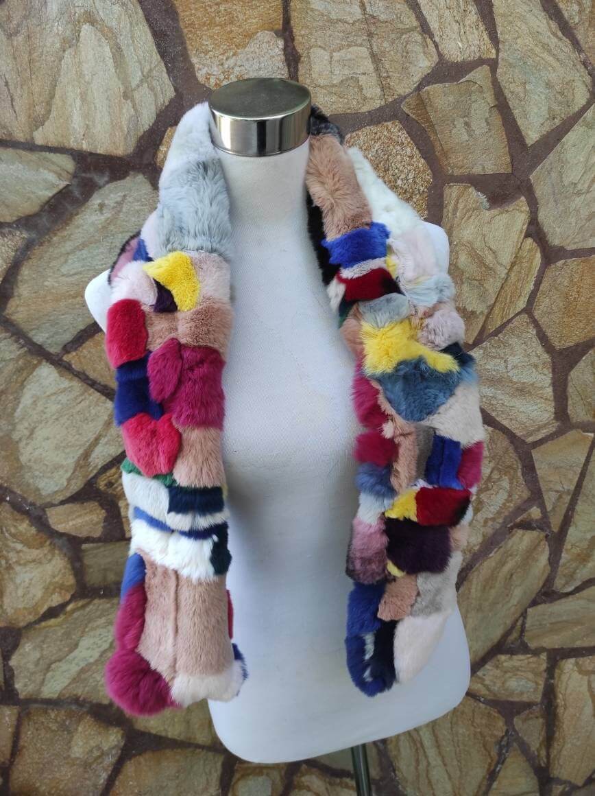 Rex Rabbit Fur Scarf Colorful - Tatifurs displayed on a mannequin with vibrant patchwork design on a stone background.