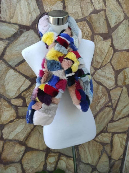Rex Rabbit Fur Scarf Colorful - Tatifurs displayed on a mannequin against a natural stone background.