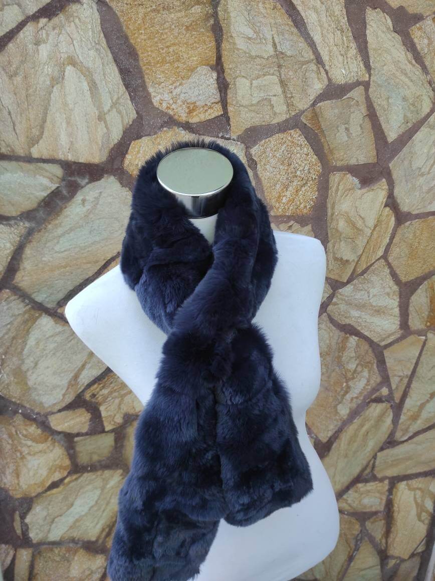 Rex Rabbit Fur Scarf Navy Blue - Tatifurs displayed elegantly on a mannequin against a stone backdrop.