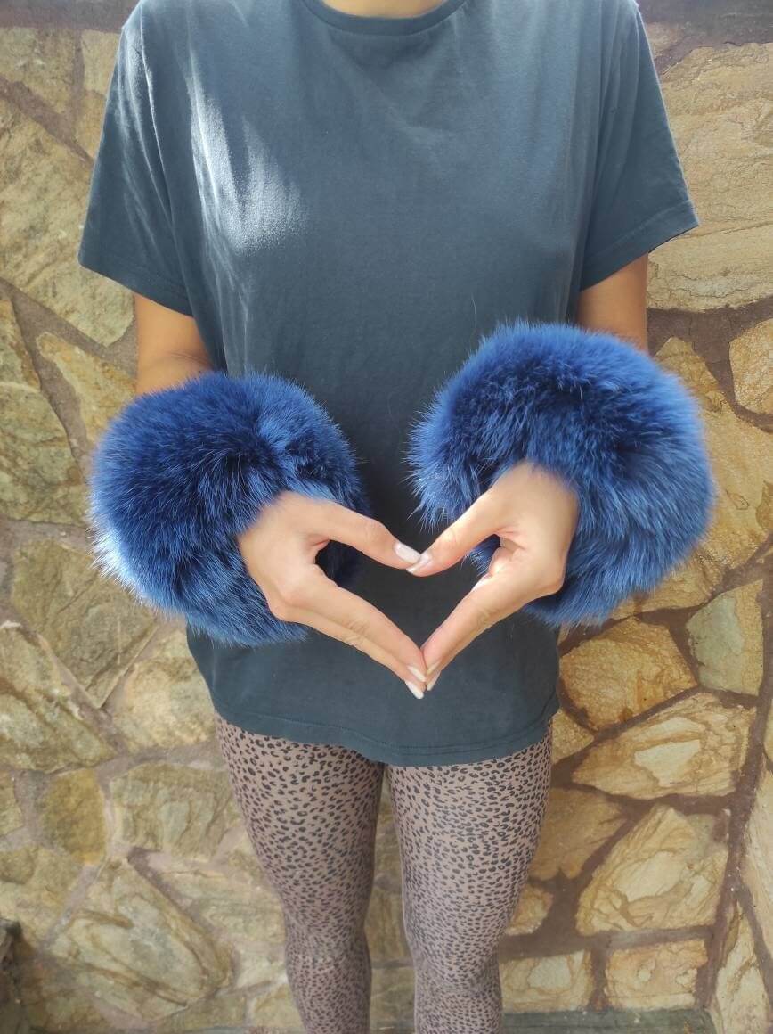 Blue Fox Fur Cuffs - Tatifurs worn by a model forming a heart shape with hands.