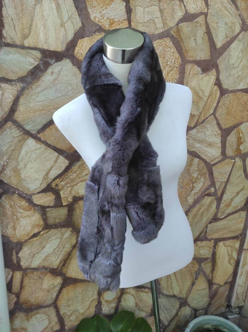Rex Rabbit Fur Scarf Gray - Tatifurs displayed on a mannequin against a stone backdrop.