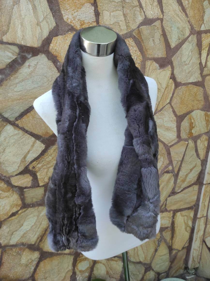 Rex Rabbit Fur Scarf Gray - Tatifurs displayed on a mannequin against a stone wall background.