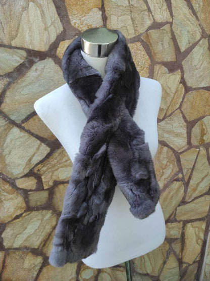 Rex Rabbit Fur Scarf Gray - Tatifurs displayed on a mannequin against a stone backdrop.