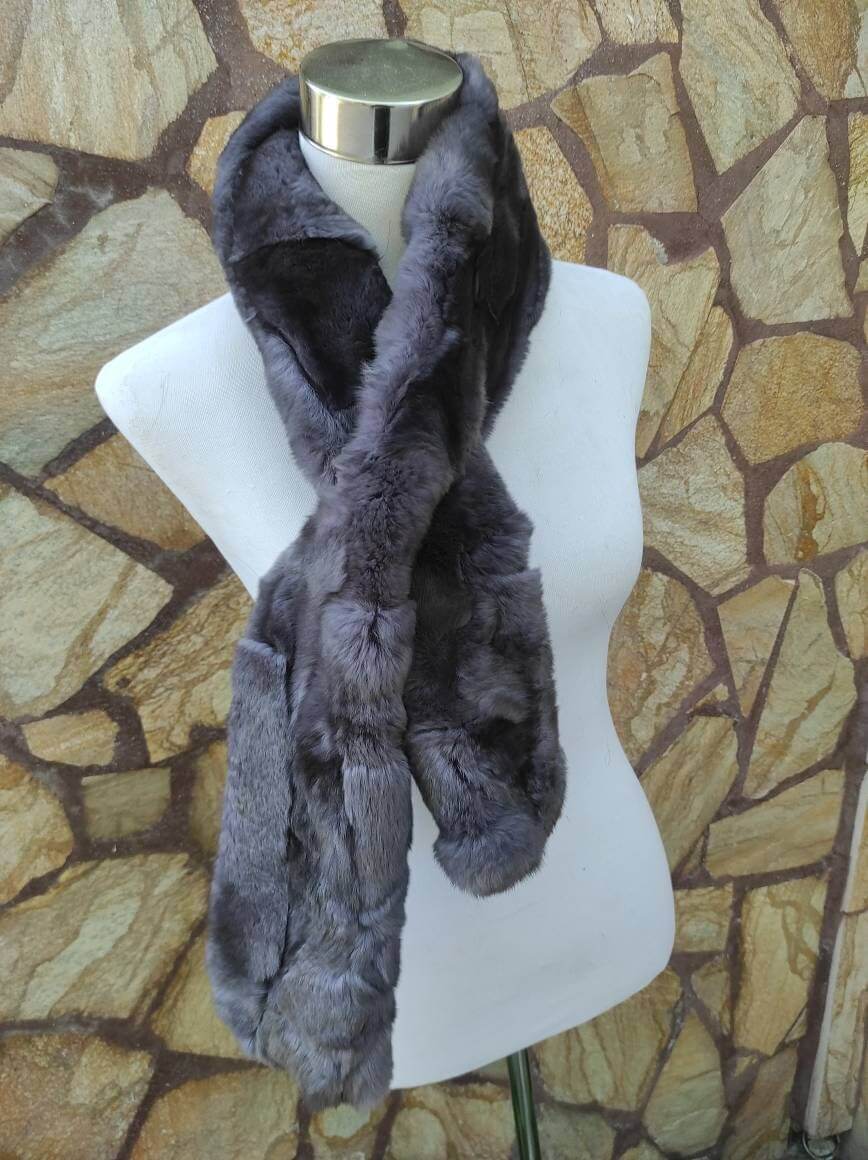 Rex Rabbit Fur Scarf Gray - Tatifurs displayed on a mannequin against stone background, showcasing softness and elegance.