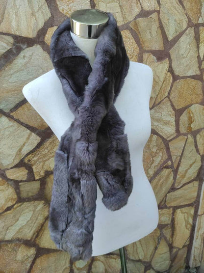 Rex Rabbit Fur Scarf Gray - Tatifurs displayed on a mannequin against stone background, showcasing softness and elegance.