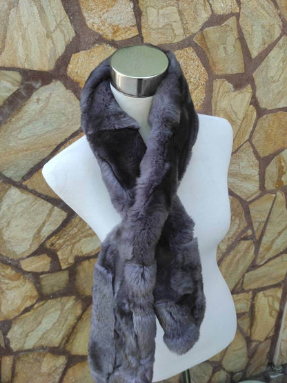 Rex Rabbit Fur Scarf Gray - Tatifurs displayed on a mannequin against a stone background, showcasing its luxurious soft texture.