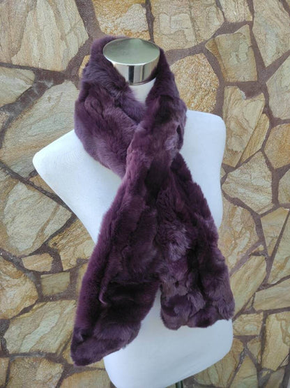 Rex Rabbit Fur Scarf Purple - Tatifurs displayed on a mannequin against a stone background, showcasing its rich purple color.