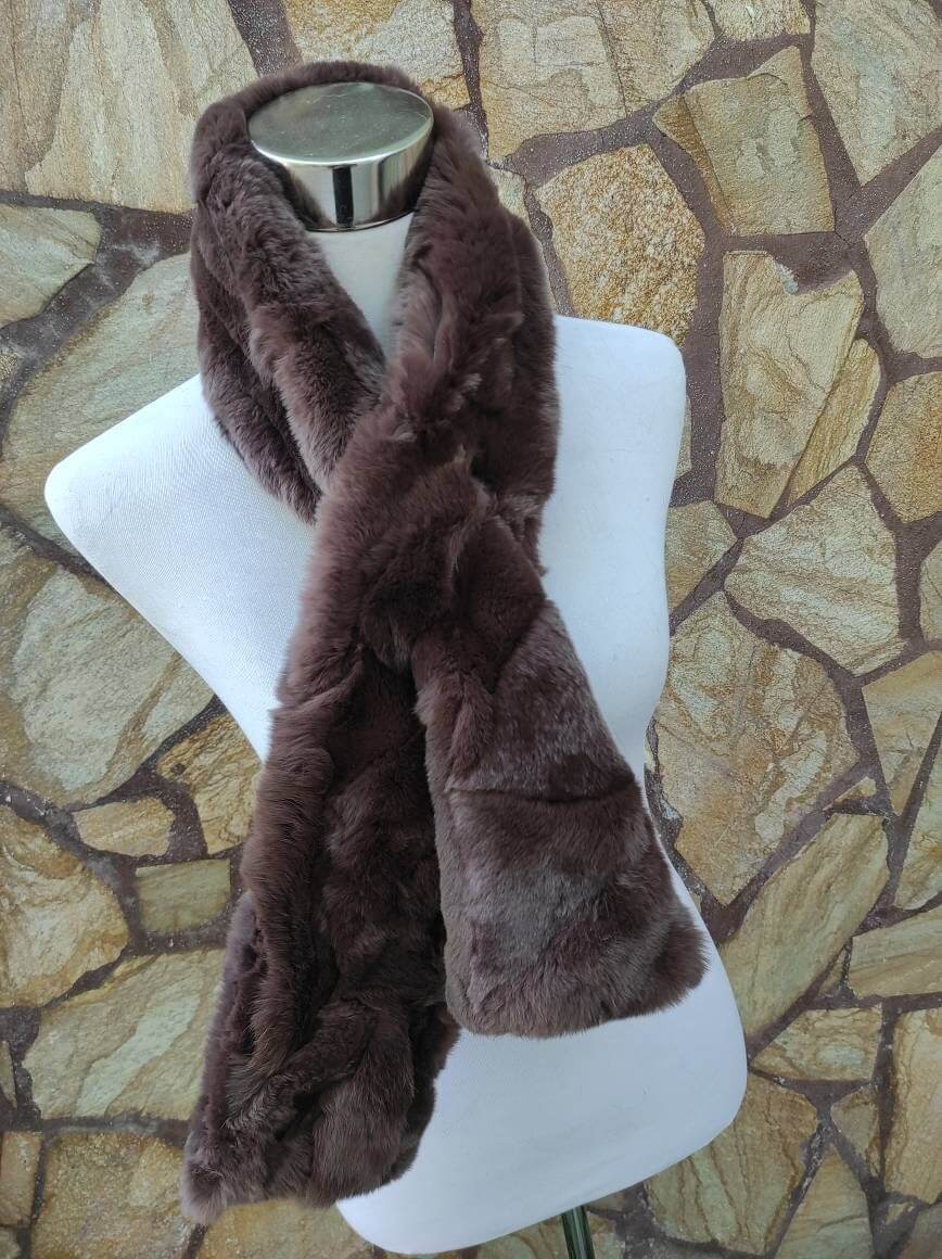 Rex Rabbit Fur Scarf Chocolate Brown - Tatifurs styled on a mannequin against a stone background.
