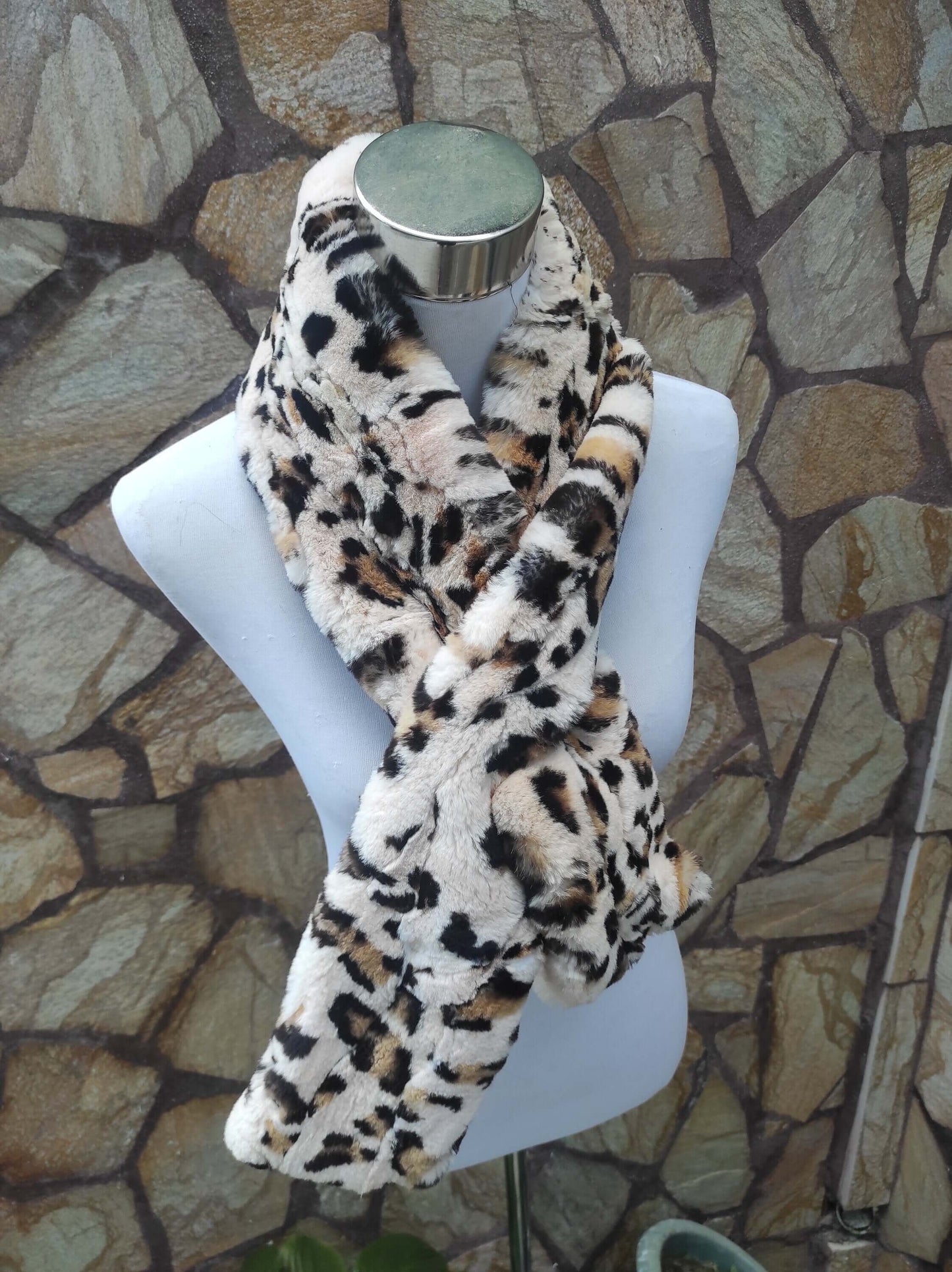 Rex Rabbit Fur Scarf Leopard - Tatifurs displayed on a mannequin against stone background.