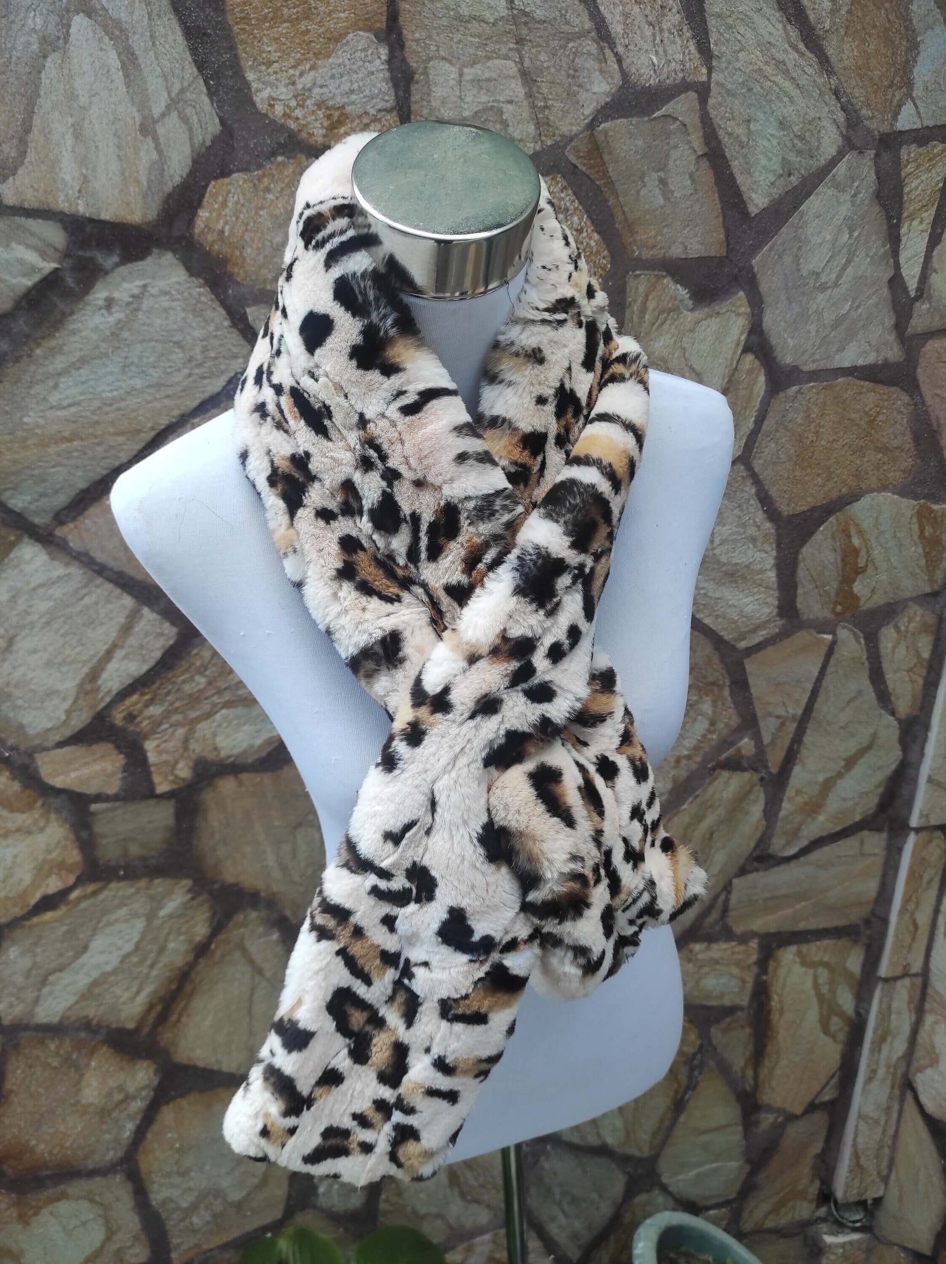 Rex Rabbit Fur Scarf Leopard - Tatifurs displayed on a mannequin against stone background.