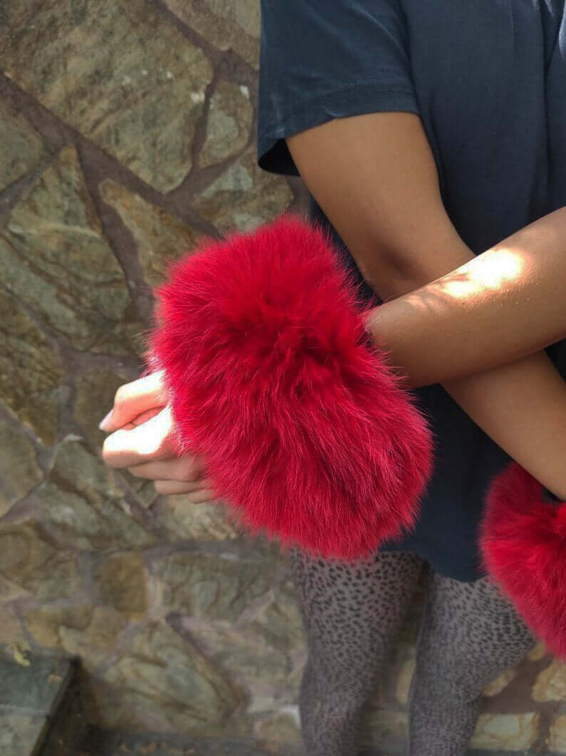 Red Fox Fur Cuffs - Tatifurs worn on wrists, showcasing luxurious red fox fur and bold style.