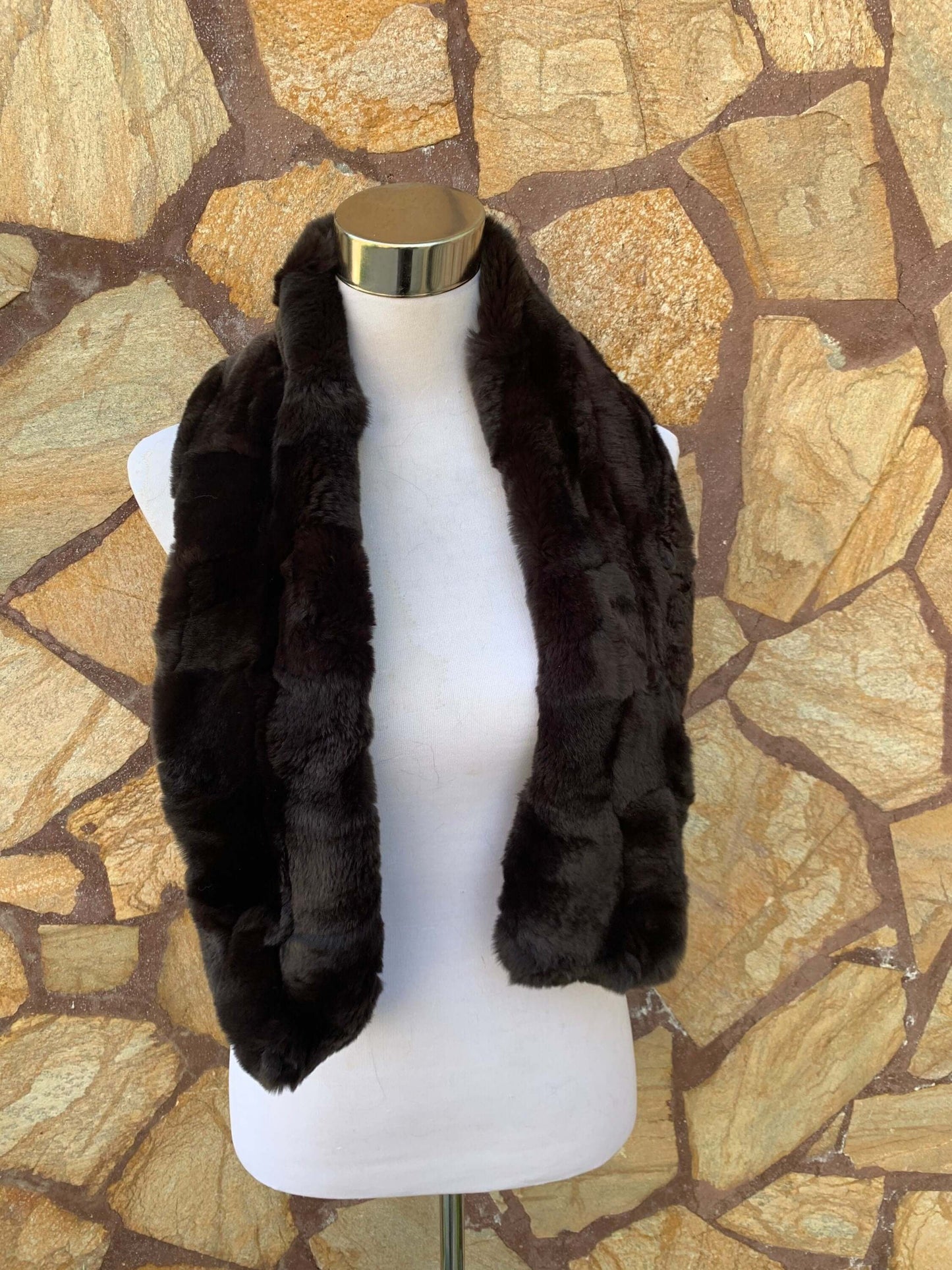 Rex Rabbit Fur Scarf Dark Brown - Tatifurs displayed on a mannequin against a stone wall background.