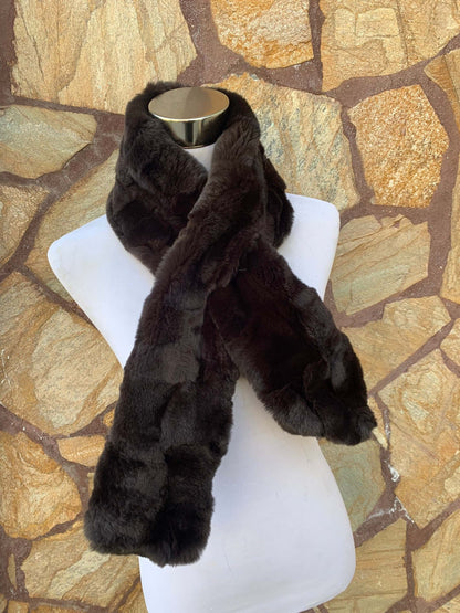 Rex Rabbit Fur Scarf Dark Brown - Tatifurs displayed on a mannequin against a stone backdrop.