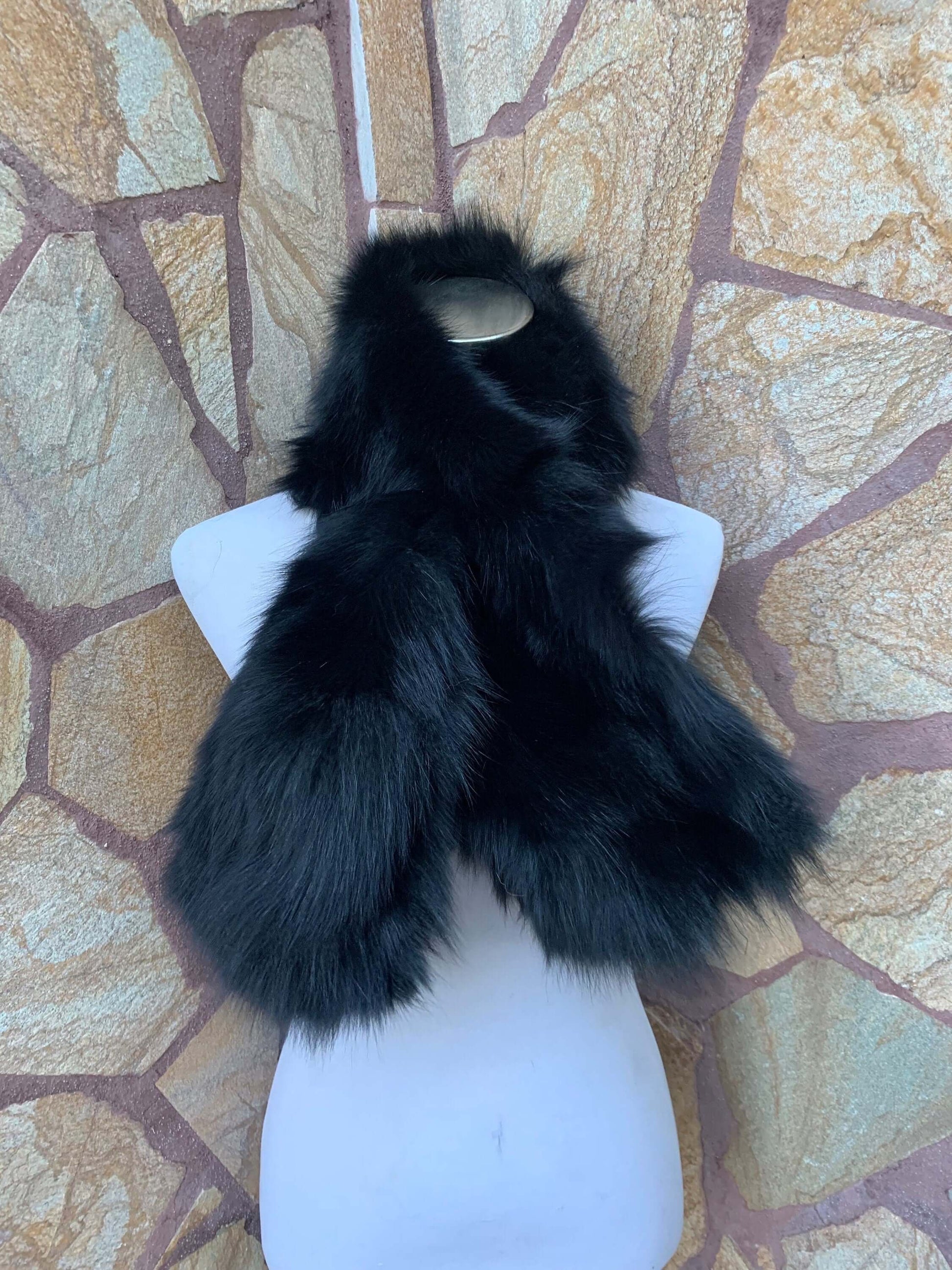 Fox Fur Scarf Black - Tatifurs displayed on a mannequin against a stone background.
